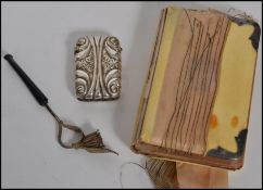 A silver white metal filigree opium pipe together with a silver plated match vesta and a silver