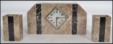 A 1920s Art Deco French marble mantel three piece clock and garniture set of angular form having