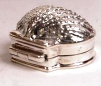 An unusual silver pill box in the form of a clam s