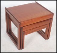 A 1970's teak wood nest of tables having a quadril