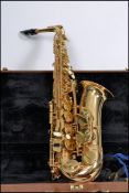 A Earlham alto saxophone, brass plated with contra