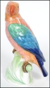 A late 19th century Mintons Majolica parrot hand painted with shades of blue green and orange raised