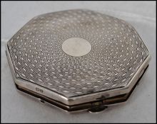 A silver hallmarked ladies compact by Vogue with e