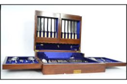 A good Edwardian large metamorphic mahogany cased canteen of cutlery. The case opening to reveal