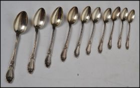 A set of ten silver tea spoons decorated in a Monte Carlo style pattern having sloped terminals