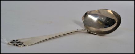 A large Danish silver  serving spoon - pouring ladel  with fabulous pierced rococo handle top. The