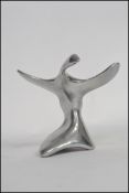 A Canadian silver white metal sculpture of abstract form depicting a bird with artist mark to base.