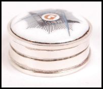 A 20th century circular silver and enamel set pill