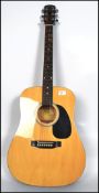 A vintage acoustic six string Squire Fender guitar