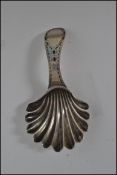 A silver hallmarked Georgian caddy spoon with shell shaped bowl and curved handle. Hallmarked to