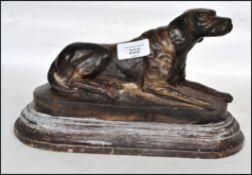 A 20th century cast bronze sculpture of a Boxer dog raised on a naturalistic plinth in the manner of