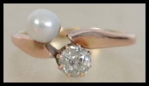 An early 20th century 9ct gold diamond and natural pearl ring. Diamond approx 30pts. Pearl