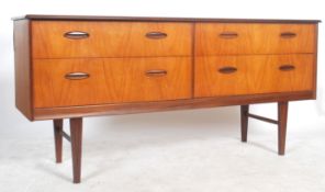 A 1970's retro Danish influence teak wood sideboard raised on tapered legs with a series of 4