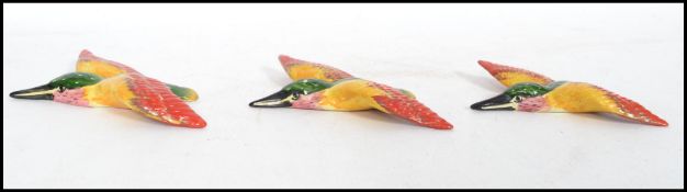 A group of three Art Deco ceramic wall plaques in