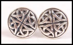 A pair of contemporary silver and onyx inset gentleman's cufflinks / cuff links of celtic influence.
