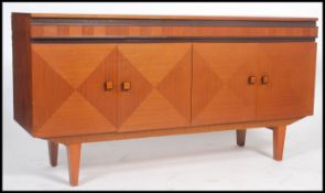 A 1970's Teak wood sideboard having diamond design two-tone veneer doors and alternating patterned