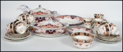 An Imari pattern 19th century part dinner service to include tureens and dinner plates etc
