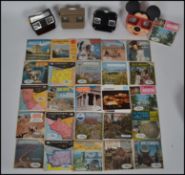 A collection of vintage Viewmasters slide viewers and slides to include Disney Mickey Mouse example,