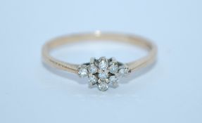 A hallmarked 9ct gold and diamond cluster ring. Hallmarked London. Size M.