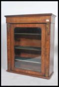 A Victorian walnut single door pier cabinet having