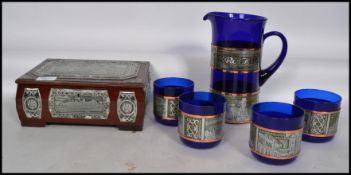A collection of Polish blue glass having white metal decorative banding to include four tumblers,