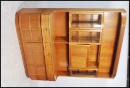 A 1970's G-Plan style teak wood sideboard comprising a base with drawers and cupboards having an