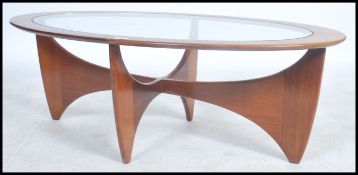 A 1970's G-Plan oblong teak model  ' Astro ' coffee table, with inset circular glass top over
