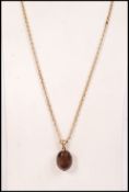 A stunning 9ct / 375 hallmarked citrine pendant and necklace chain. The oval citrine in hallmarked