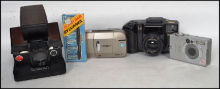 A group of vintage 20th century cameras to include an early Polaroid SX - 70 folding land camera