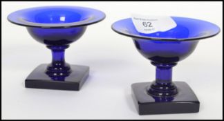 A rare pair of 18th century Bristol blue salt cellars raised on square plinth bases with waisted