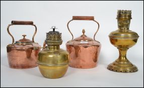2 good Victorian copper kettles in the manner of Edward Wilkes together with a brass oil lamp and
