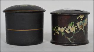 Two early 20th century ladies vanity potted puffs, both ebonised, one of wooden construction hand