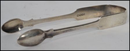 A pair of early 19th century Georgian hallmarked silver sugar tongs of larger proportions being