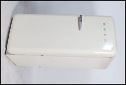 A 20th century SMEG Fridge of upright form having chrome SMEG notation to front and white enamel
