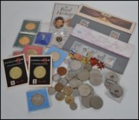 A collection of items to include vintage coins, enamel badges, stamps etc please see images.