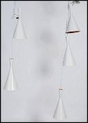 A set of five vintage retro style waisted pendant conical pendant ceiling lights after a Tom Dixon