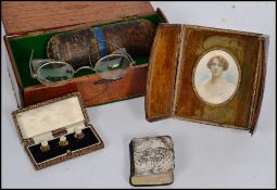 A mixed lot of various antiques to include a silver hallmarked cherub prayer book, cased spectacles,
