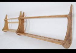 A pair of 20th century rustic country pine plate racks. Each with twin shelves with wavey end