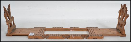 A early 20th century art deco metamorphic book trough having fret pierced end design