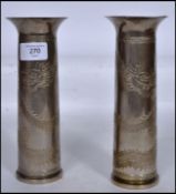 A pair of silver white metal trench art vases having flared rims with etched decoration of dragons