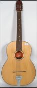 A vintage six string acoustic guitar with shaped b