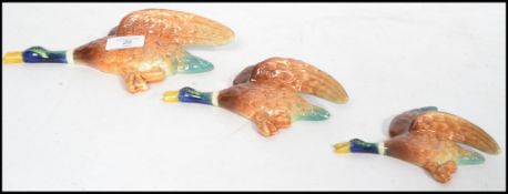 A set of three Slyvac ceramic wall hanging graduating ducks plaques, in three sizes 1401, 1402,