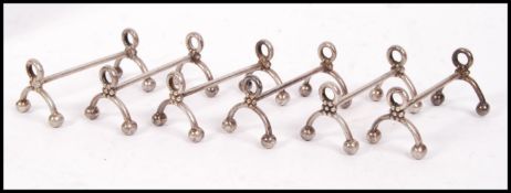 A set of 6 early 20th century Bruno Wiskemann silver plated knife rests of large form with pierced