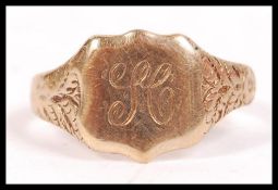 A vintage 9ct gold gents signet ring with gypsy style chase shoulders, monogram to the cartouche.