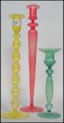 A group of three 19th century Venetian glass candlesticks raised on a circular foot with moulded