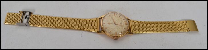 An 18ct gold vintage gentlemans Longines wristwatch having a baton numeral face with faceted hands