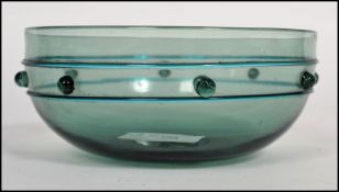 A 19th century Gothic revival Arts and Crafts movement Bristol green glass finger bowl having a