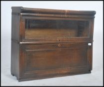 An unusual vintage globe wernicke style 2 section bookshelf with upper sliding full length glass