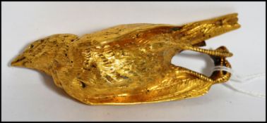 A 19th century Victorian gilt bronze paperweight in the form of a still dead bird having a leather