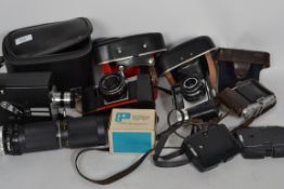 A collection of cameras to include Praktica Tuova B with lens in leather case, Voightlander Vito